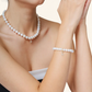 Woman wearing a faux pearl bracelet and matching pearl necklace