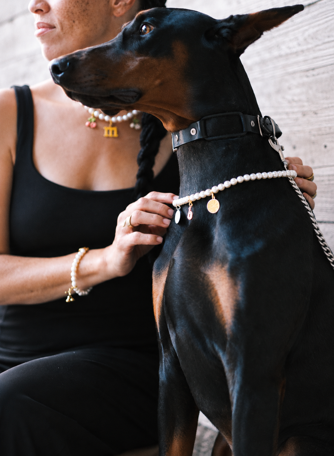 Woman and her Doberman wearing matching freshwater pearl jewelry