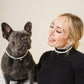 Woman and her French bulldog wearing matching freshwater pearl necklaces with letter charms
